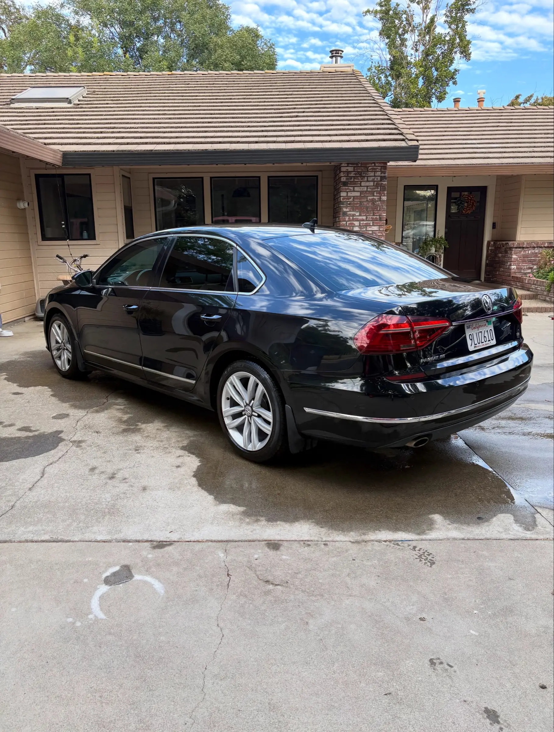 Black Volkswagen Passat in a driveway after a detail