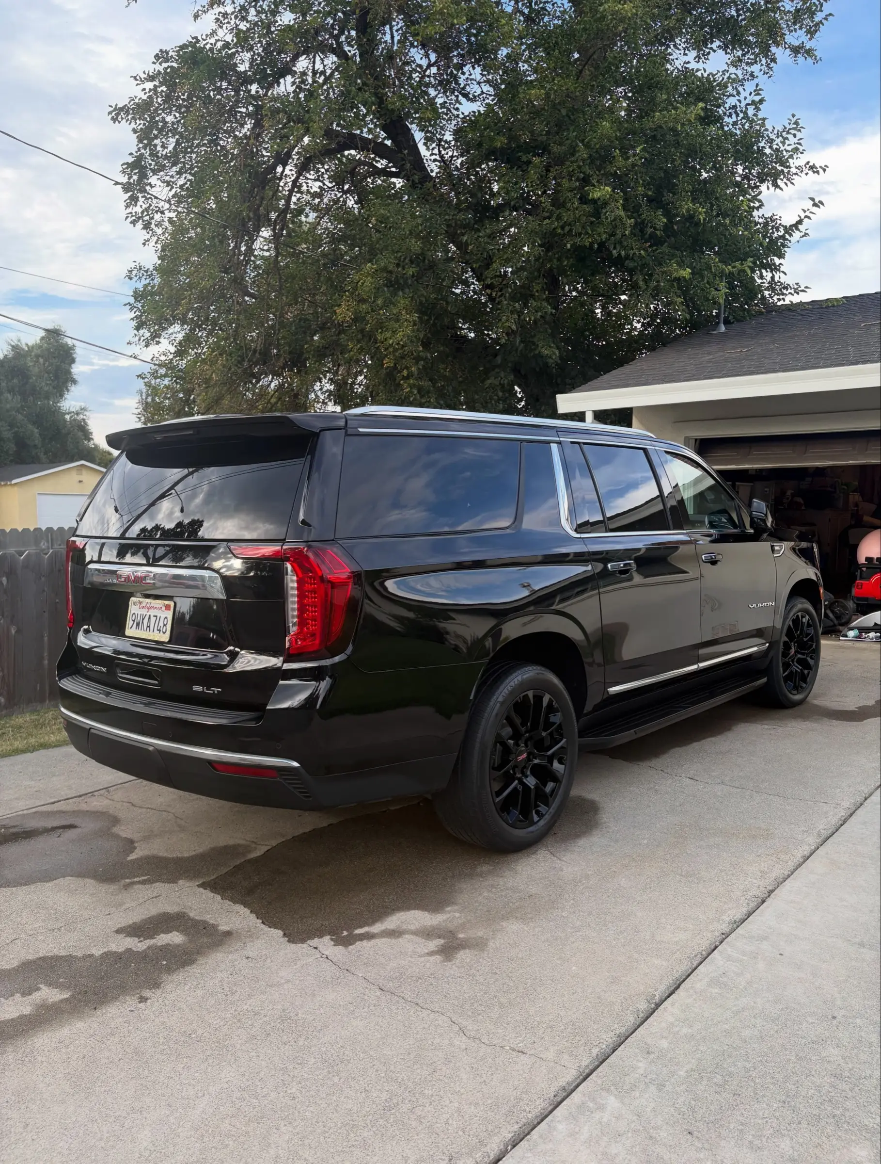 Black GMC Yukon, rear three-quarter view, after a detail