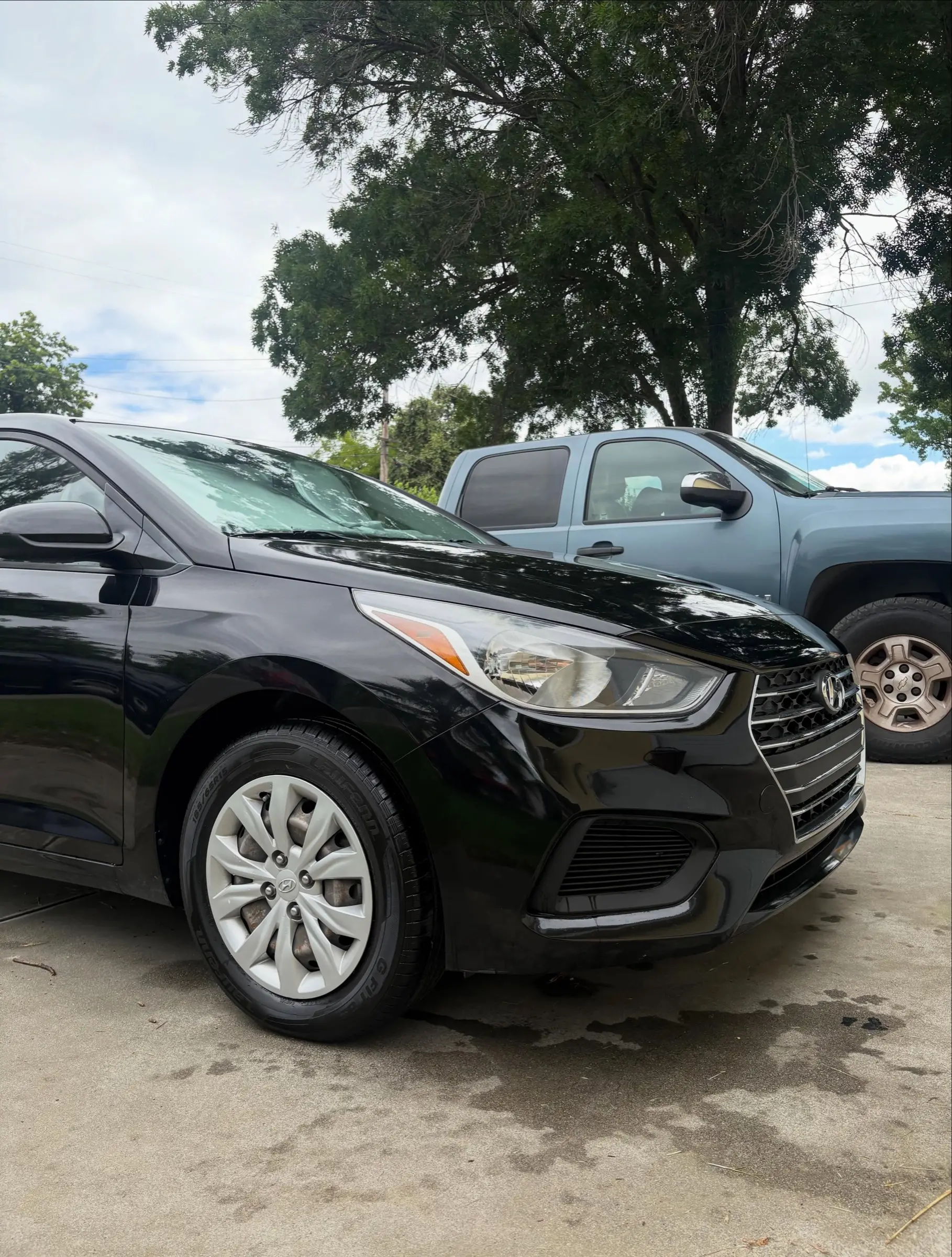 Black Hyundai Accent, front three-quarter view, after an exterior detail