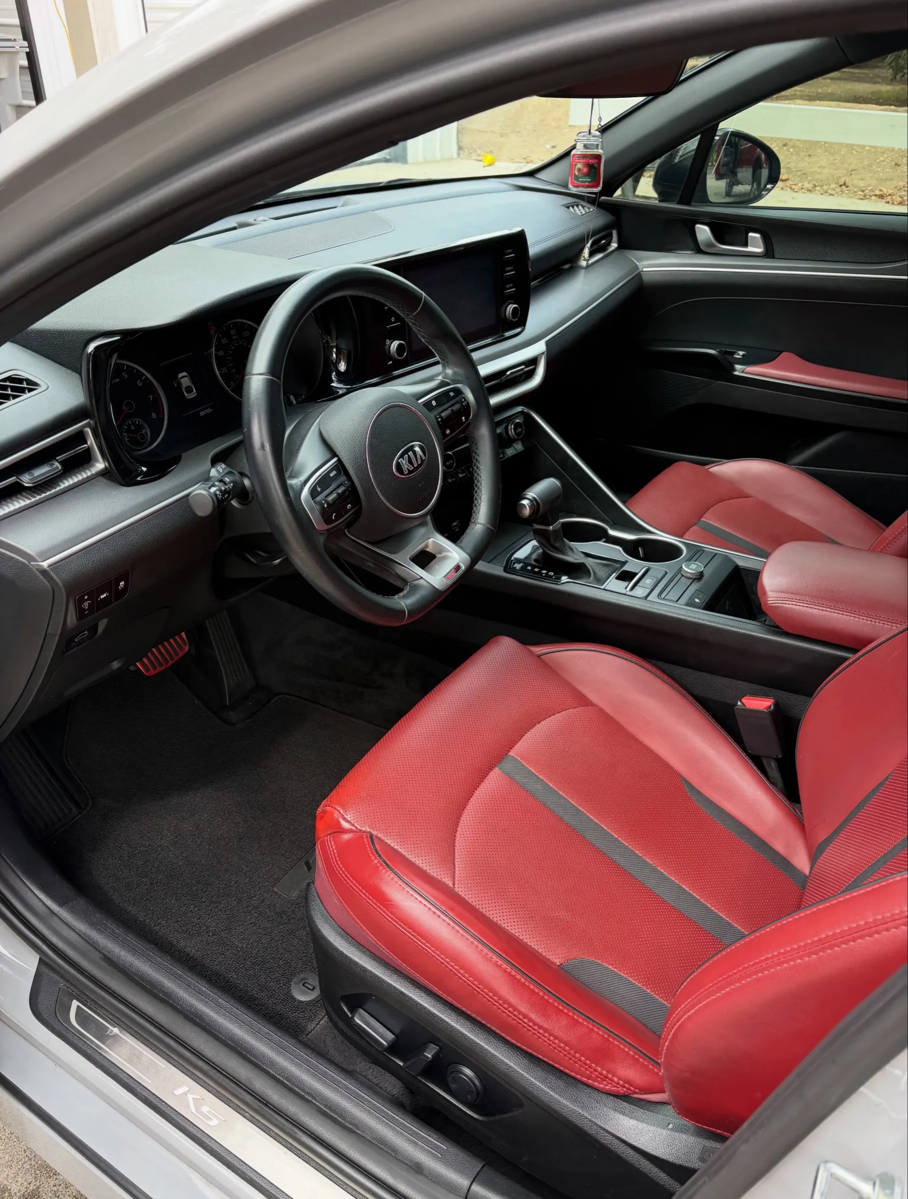 Red leather Kia K5 front seats and dash after a Full Detail