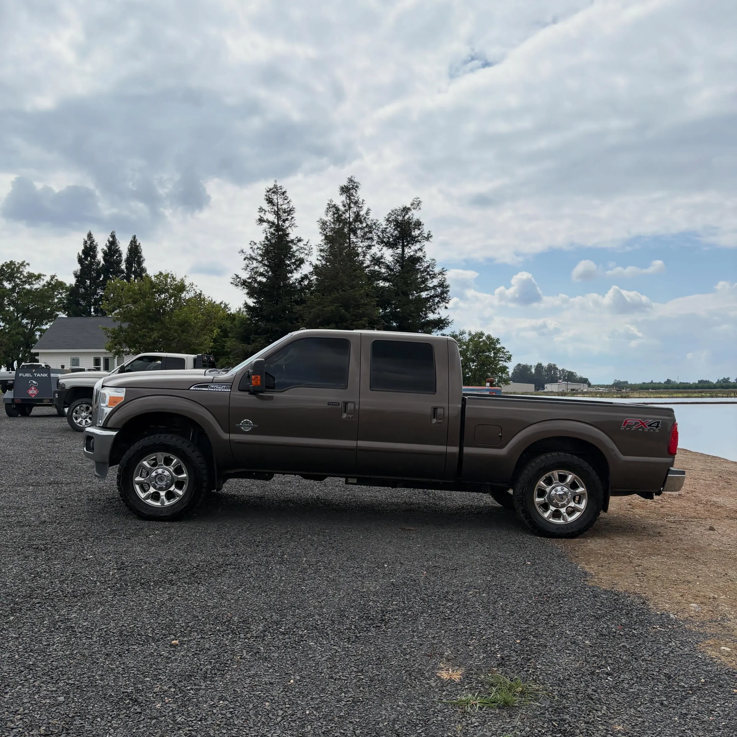 Brown Ford F-250 parked by the lake after a maintenance wash