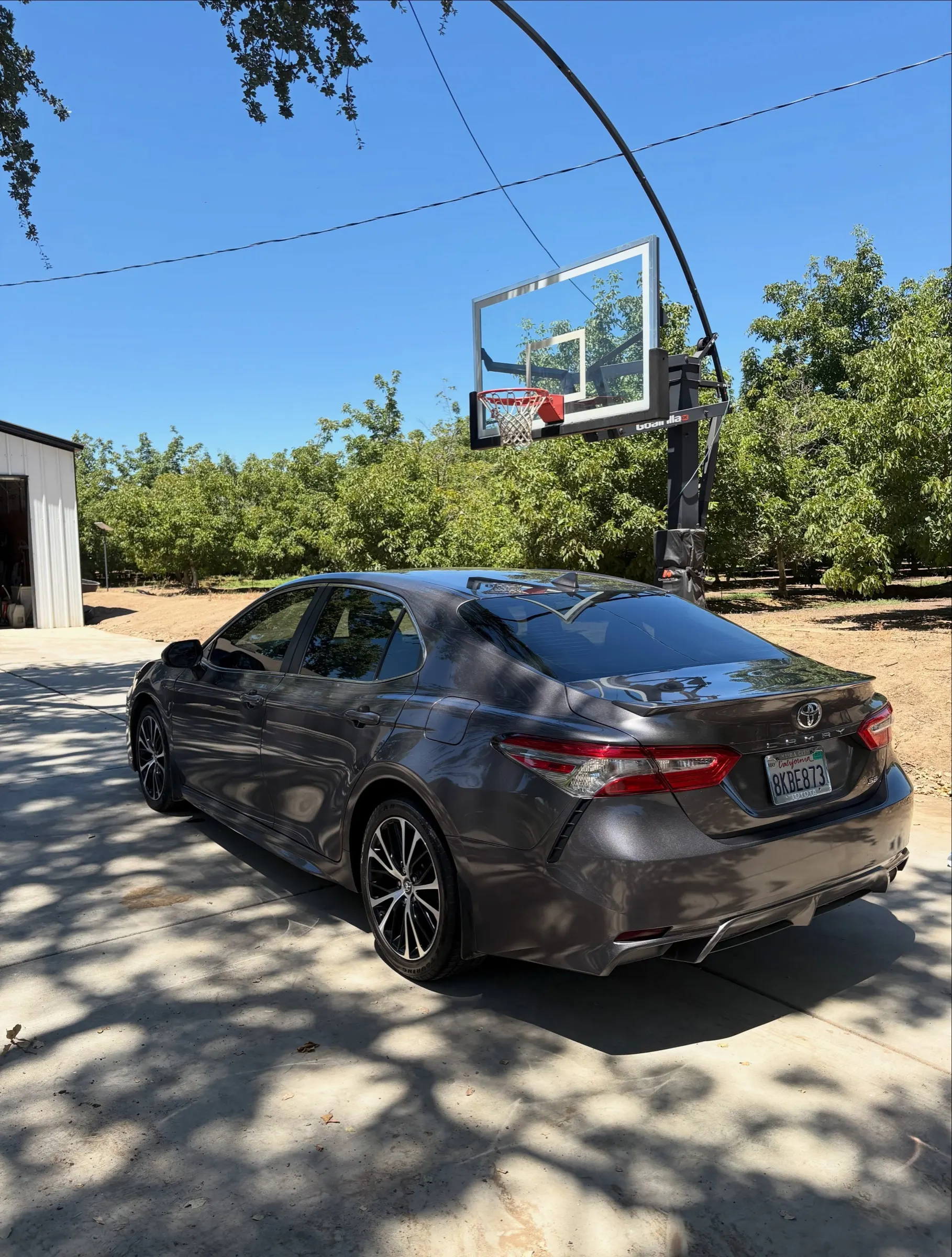 Gray Toyota Camry, rear three-quarter view, after a Refresh Detail
