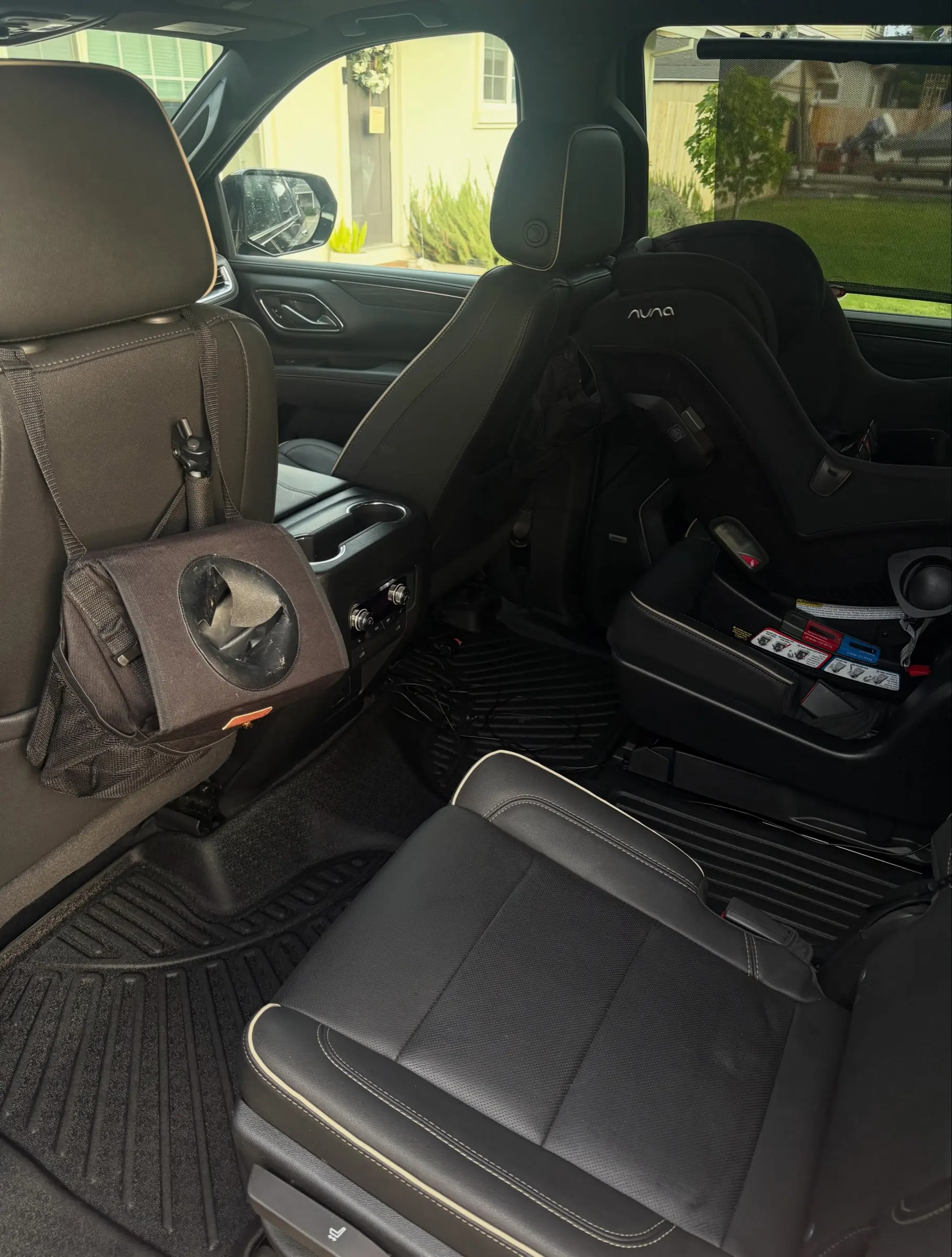 Black GMC Yukon second-row seats after an interior clean