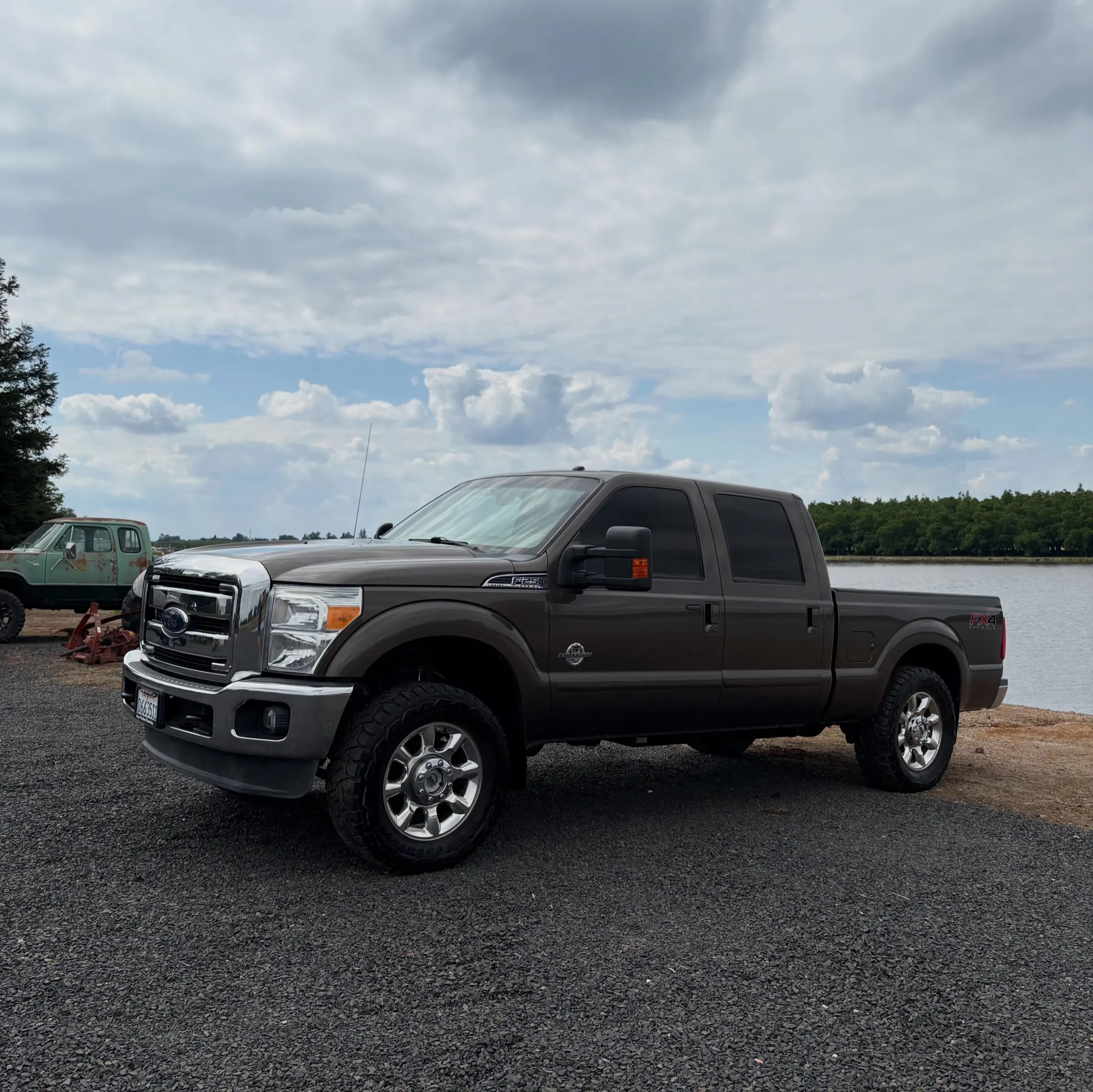 Brown Ford F-250 side view by the lake