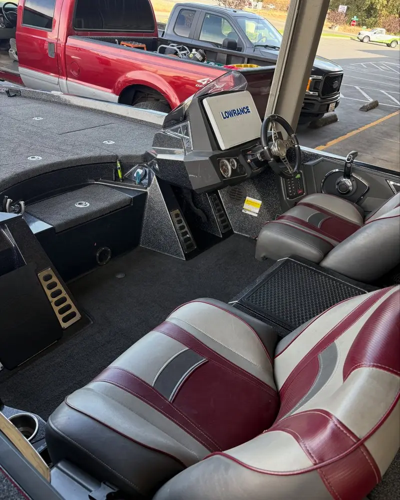 Boat cockpit with red and gray seats after an interior clean