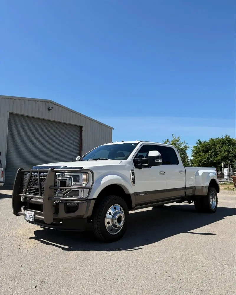 White Ford F-350 dually outside a shop after detailing